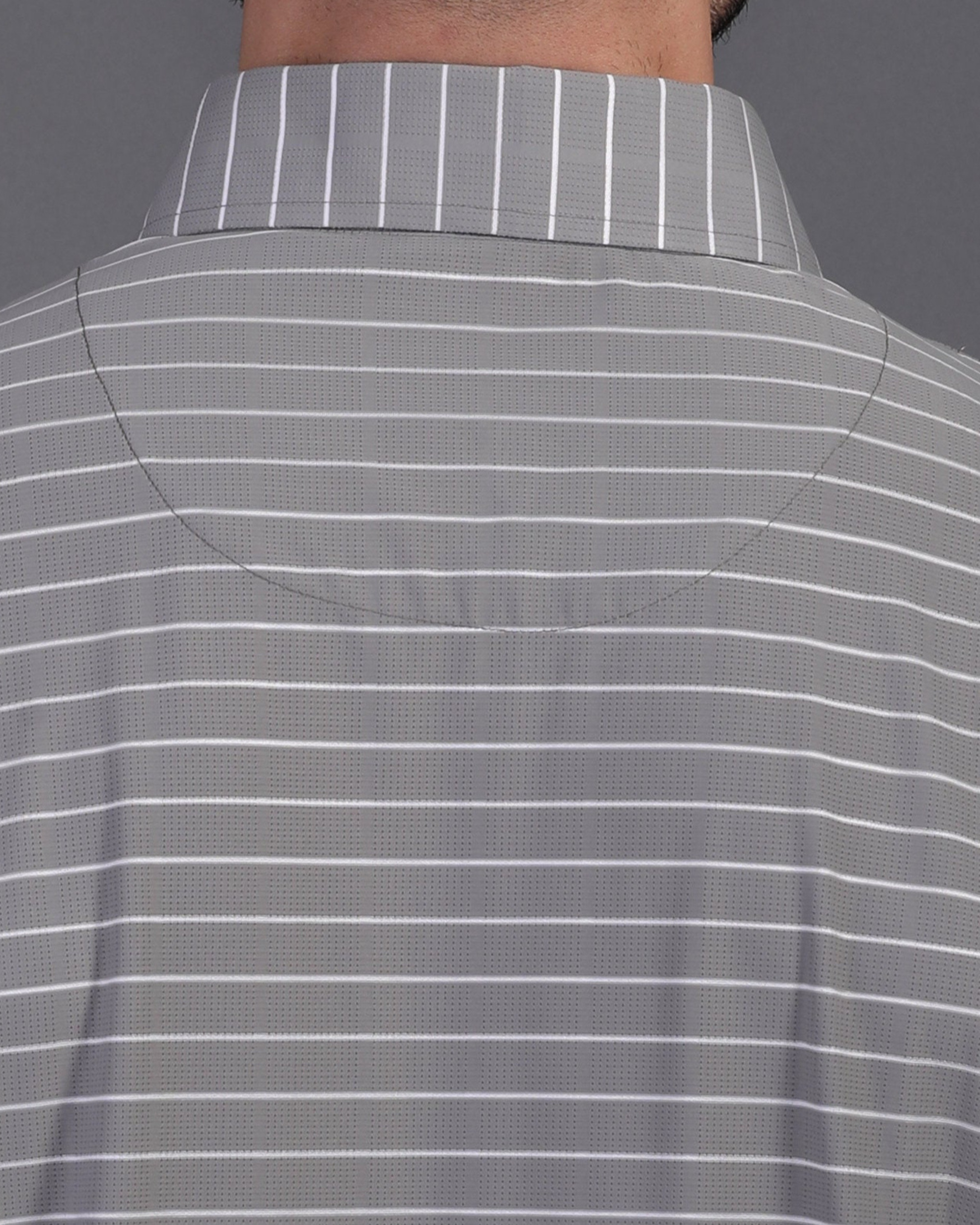 Close-up DapperTee striped polo highlighting firm collar and professional high-end tailored fit.
