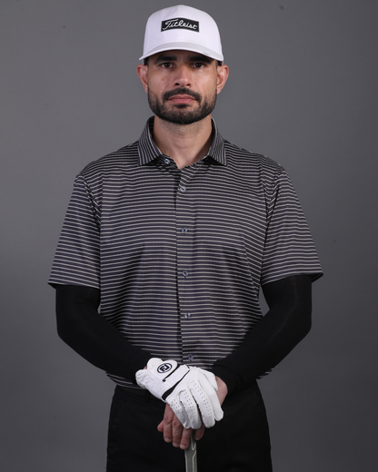 Model wearing DapperTee striped open polo for a premium corporate boardroom aesthetic.