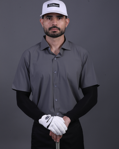 Model wearing DapperTee charcoal open polo for a premium corporate boardroom aesthetic.