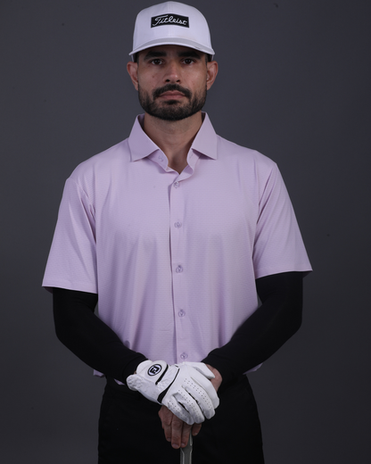Model wearing DapperTee pink open polo for a premium corporate boardroom aesthetic.