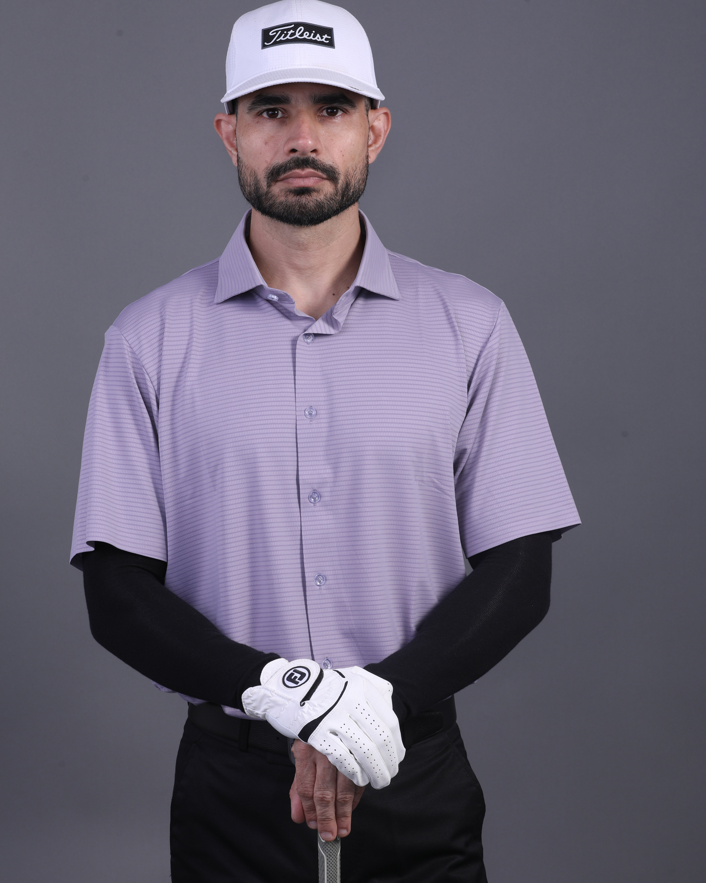 Model wearing DapperTee lavender open polo for a premium corporate boardroom aesthetic.