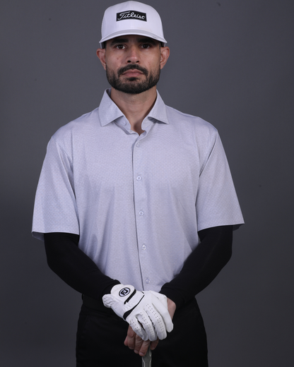 Model wearing DapperTee grey open polo for a premium corporate boardroom aesthetic.