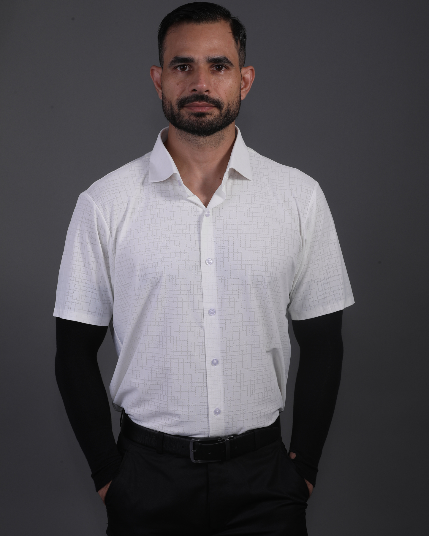Model wearing DapperTee white open polo for a premium corporate boardroom aesthetic.