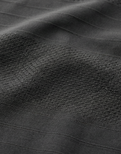 Close-up specialized jacquard polyamide fabric texture on DapperTee Scotland Yard office polo.