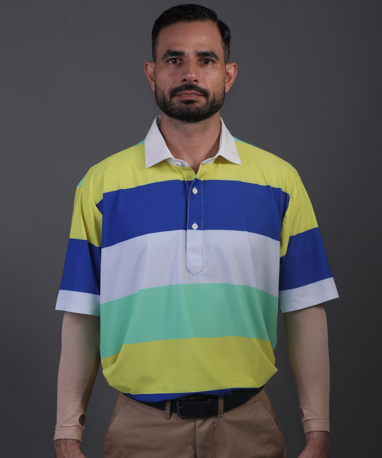 Well groomed model wearing DapperTee Pure Essential polo for premium golf aesthetic.
