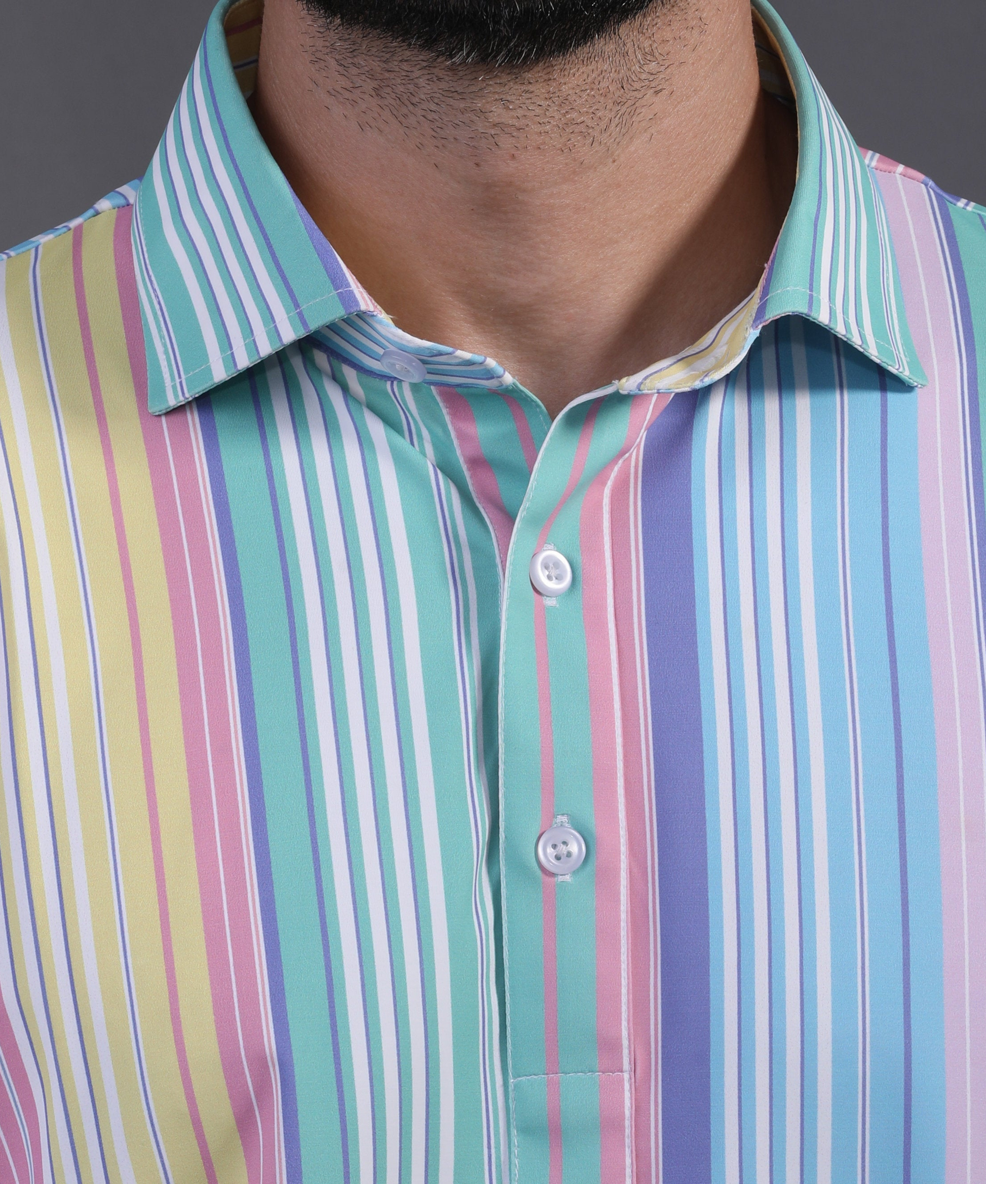DapperTee signature V-placket close-up on premium polyamide vertical stripe office wear polo.