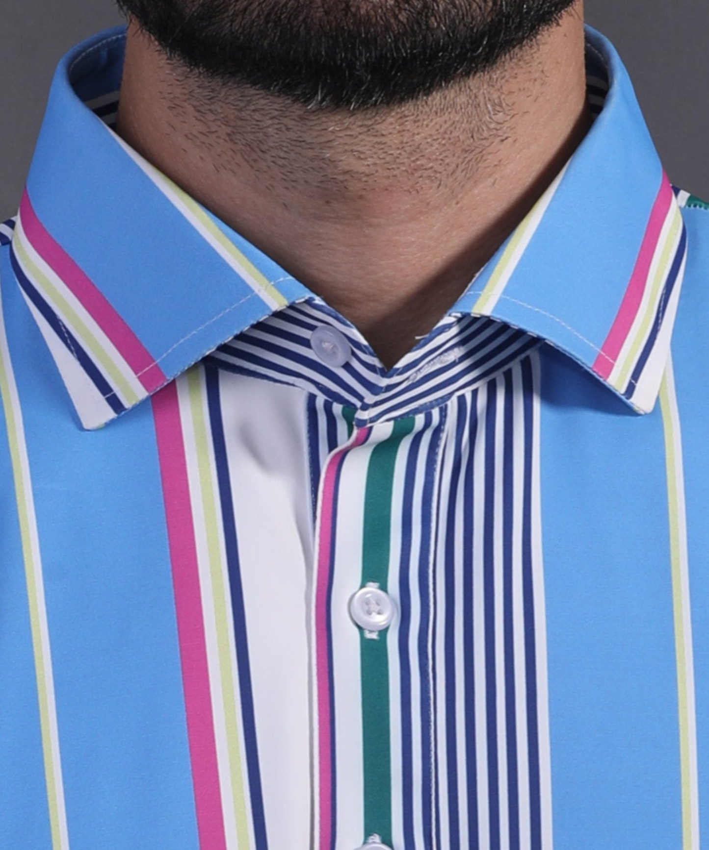 Close-up of DapperTee signature V-placket on premium polyamide blue striped polo.