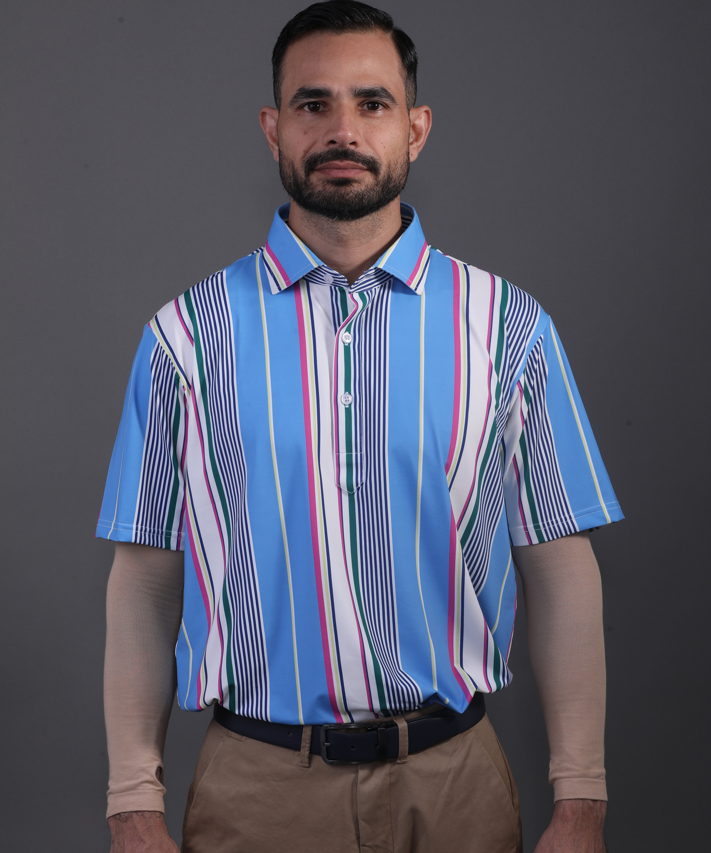 Well-groomed model in DapperTee blue striped polo for premium corporate aesthetic.