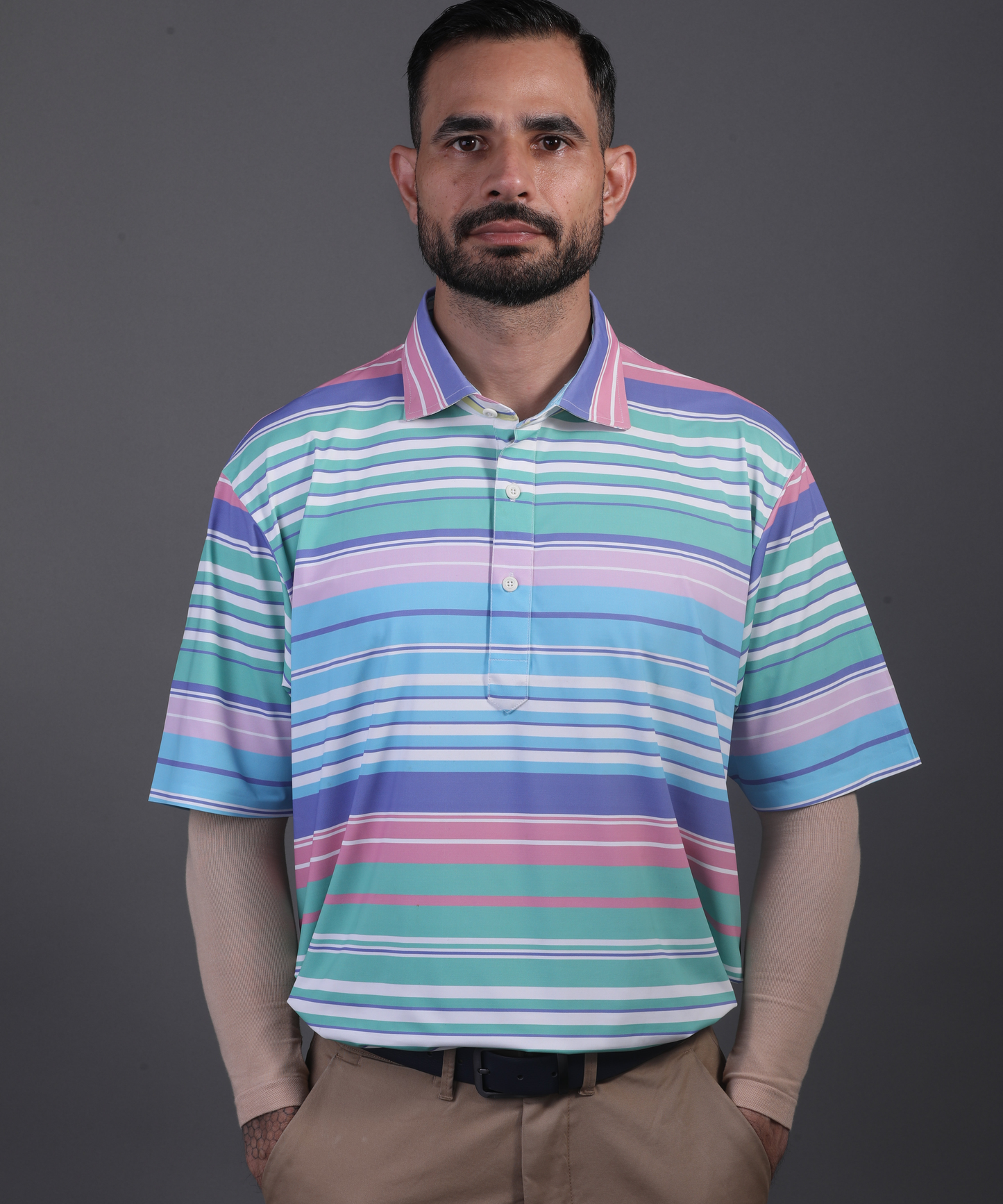 Well groomed model wearing DapperTee Super Luxe polo for premium golf aesthetic.