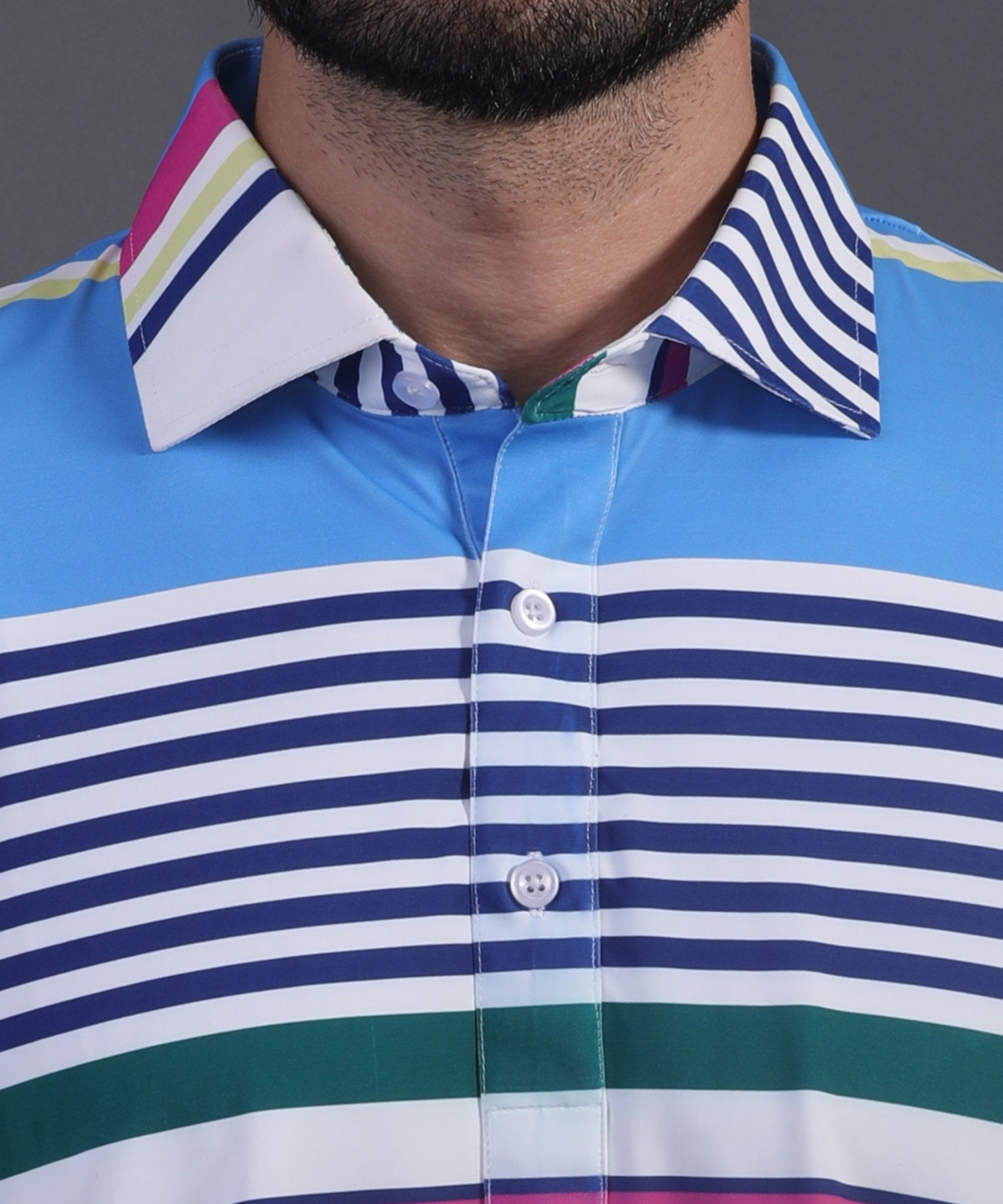 DapperTee signature V-placket close-up on premium polyamide light blue striped golf polo.