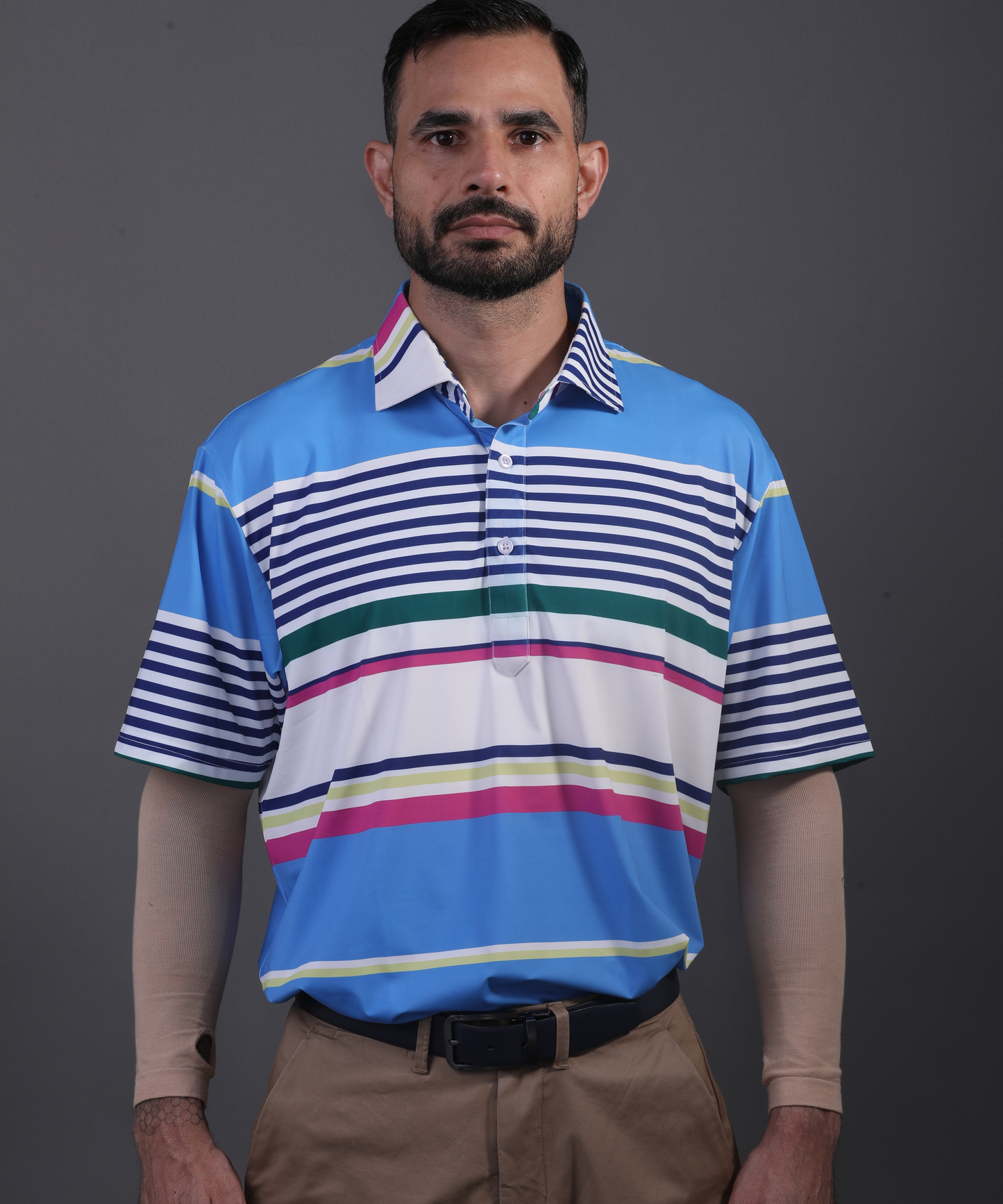 Well-groomed model in DapperTee light blue striped polo for premium golf aesthetic.