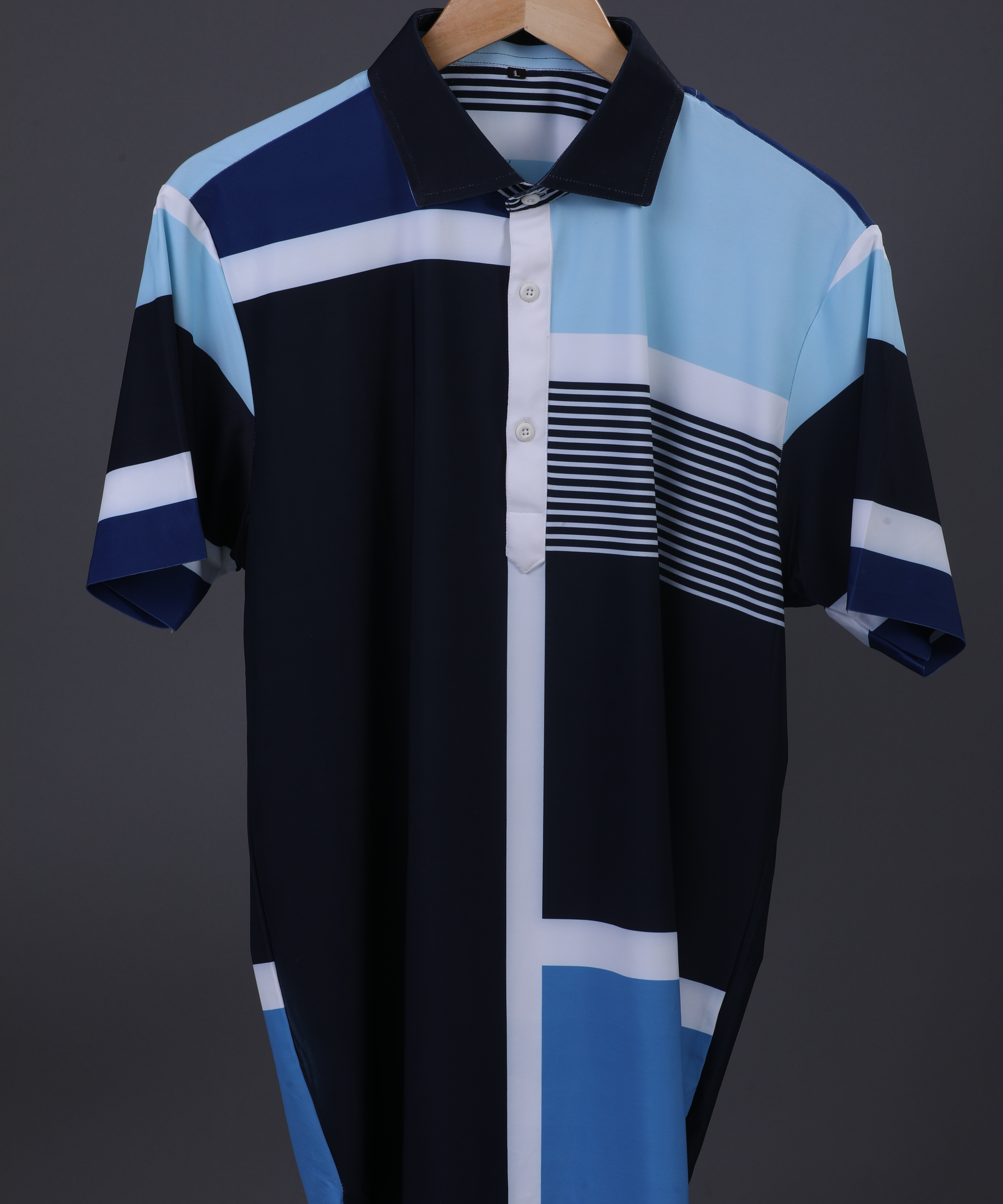 Blue DapperTee stripe polo on hanger highlighting firm collar and specialized fabric.