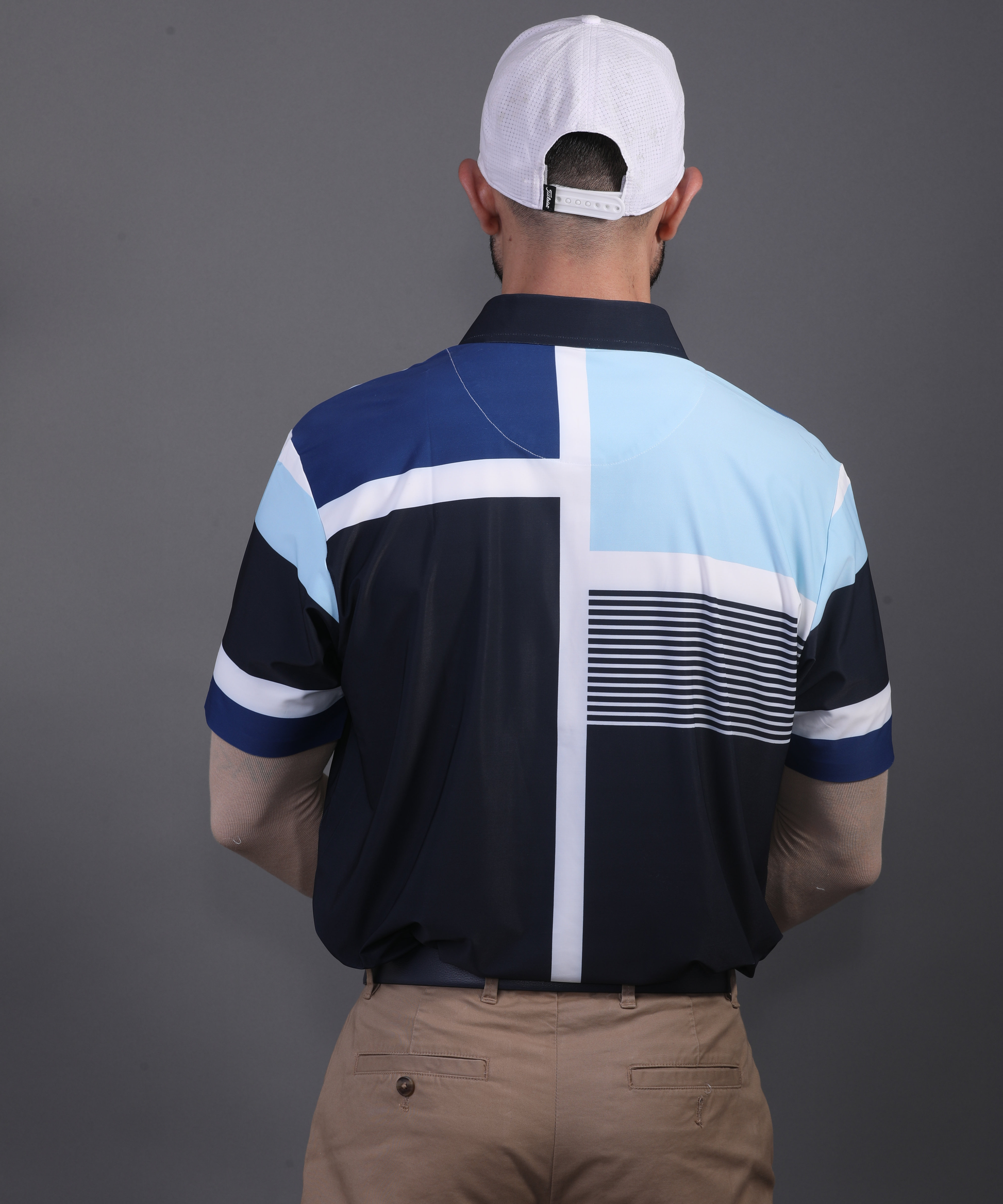 Rear view DapperTee blue stripe polo demonstrating athletic fit and stretchable comfort.
