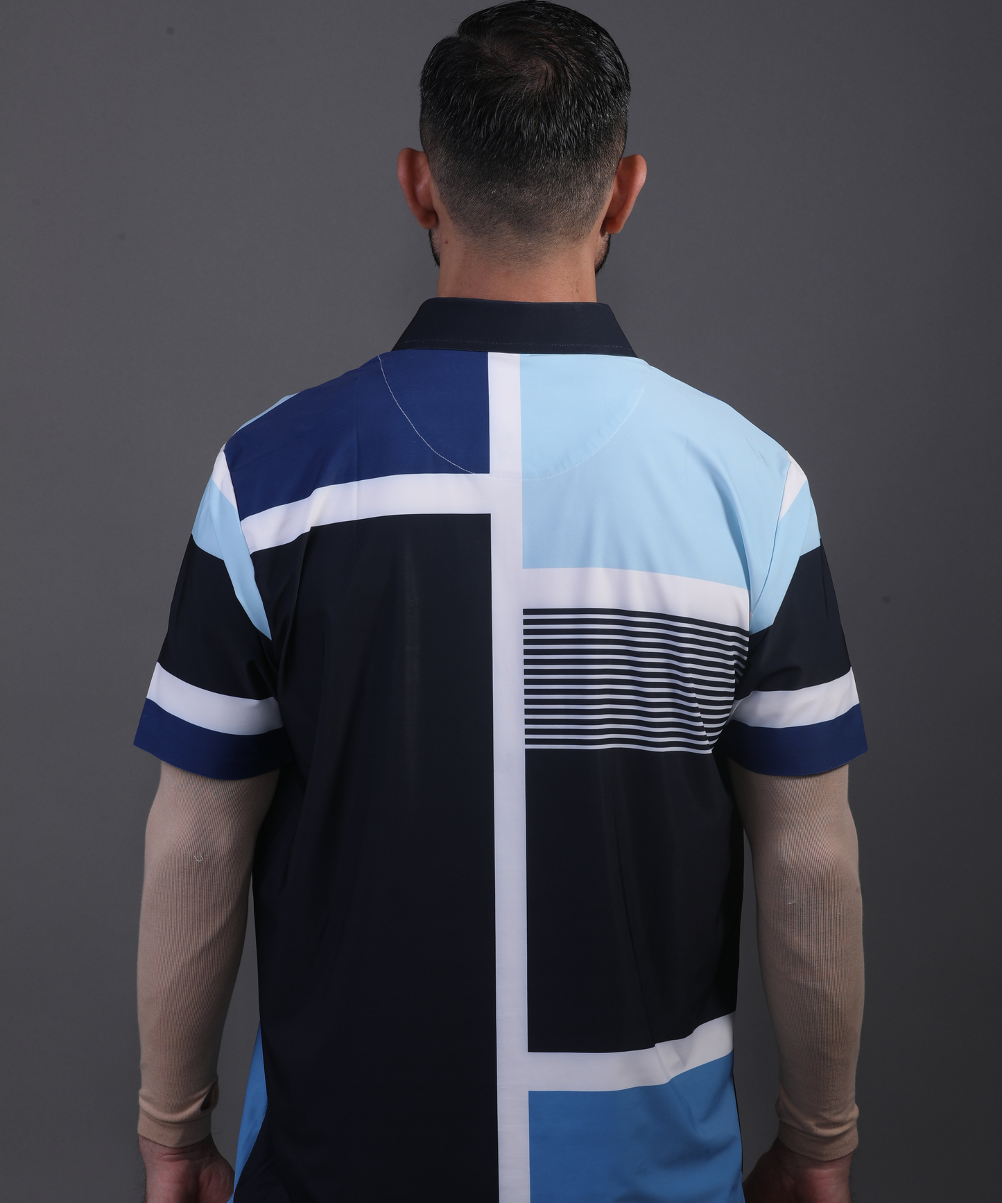 Full back view DapperTee blue stripe polo for professional men's Golf style.