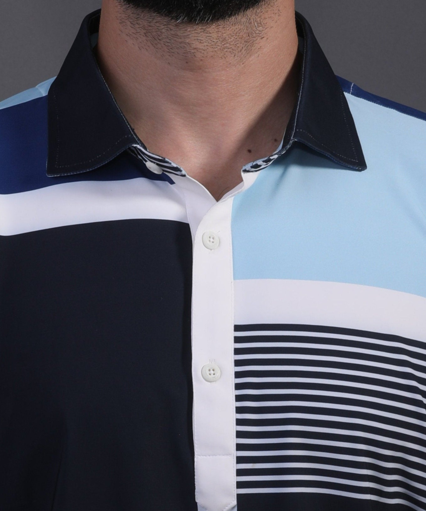 DapperTee signature V-placket close-up on premium polyamide blue striped office wear polo.