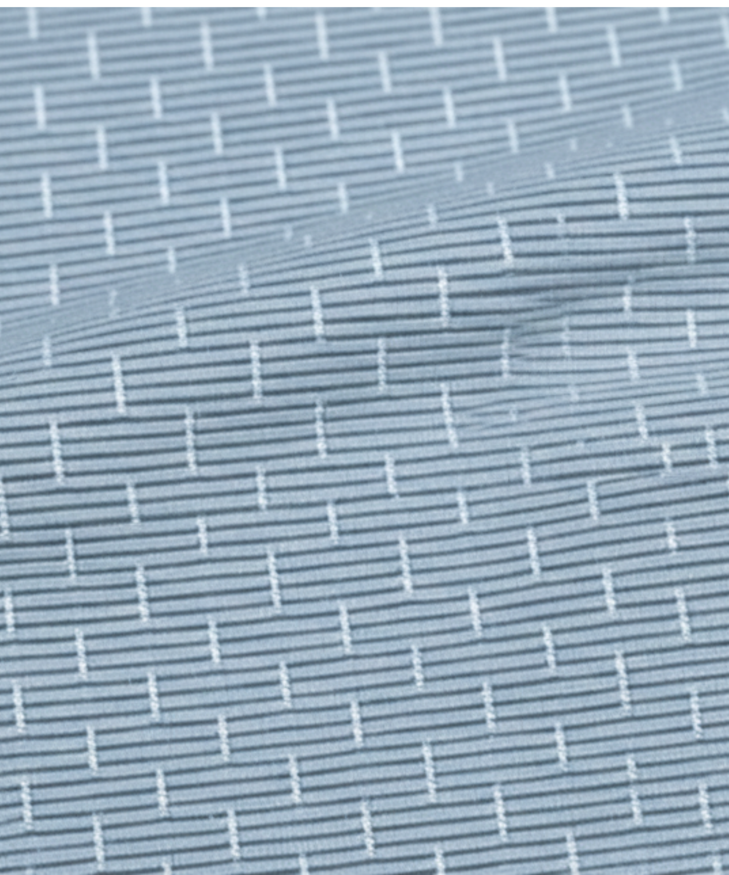 Close-up specialized jacquard polyamide fabric texture on DapperTee Swede Sea blue shirt.