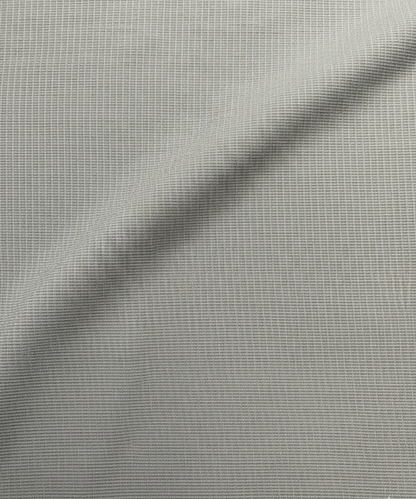 Close-up specialized jacquard polyamide fabric texture on DapperTee Fort Knox gold shirt.