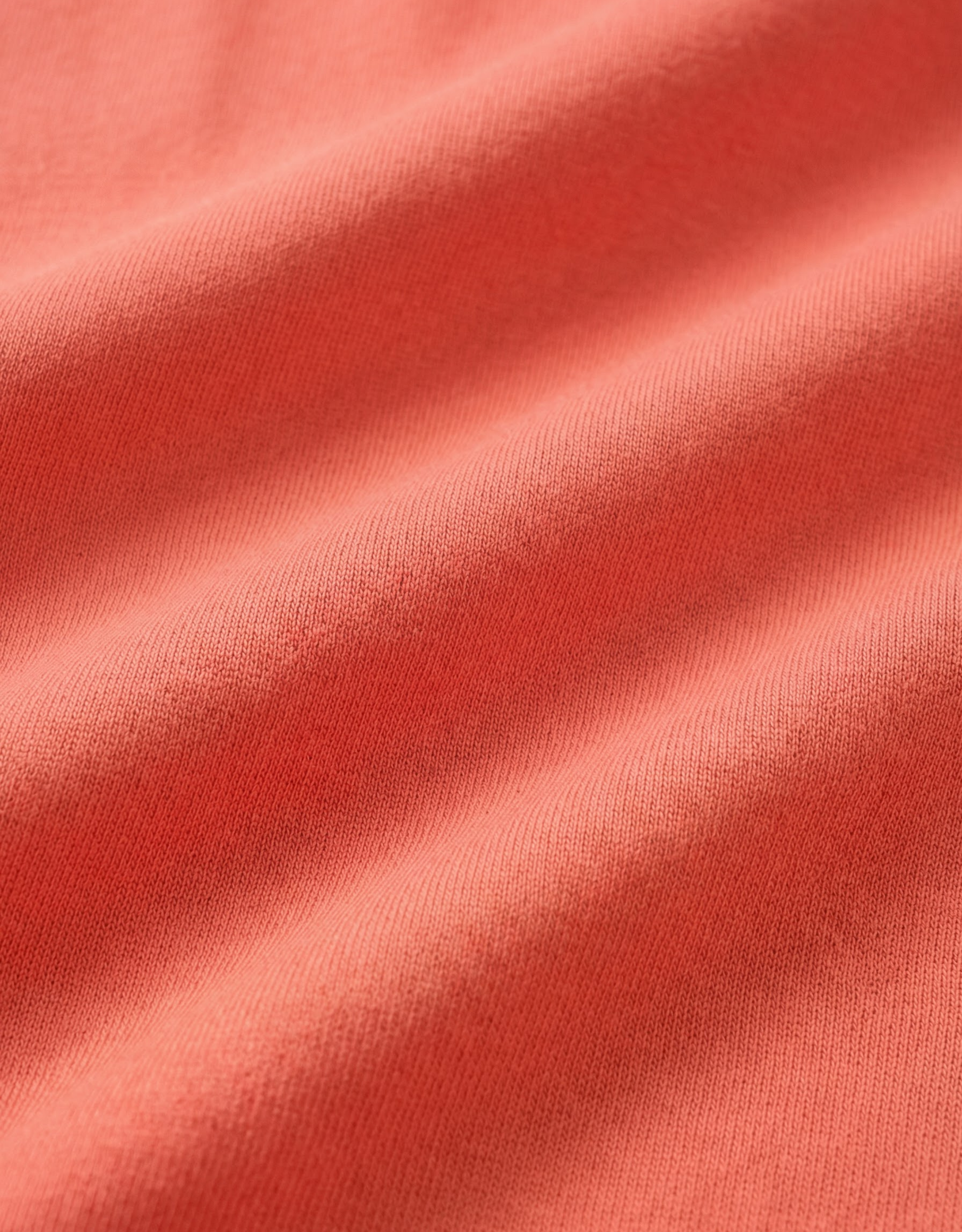 Close-up specialized polyamide fabric texture on DapperTee Japan Sun rust office polo.