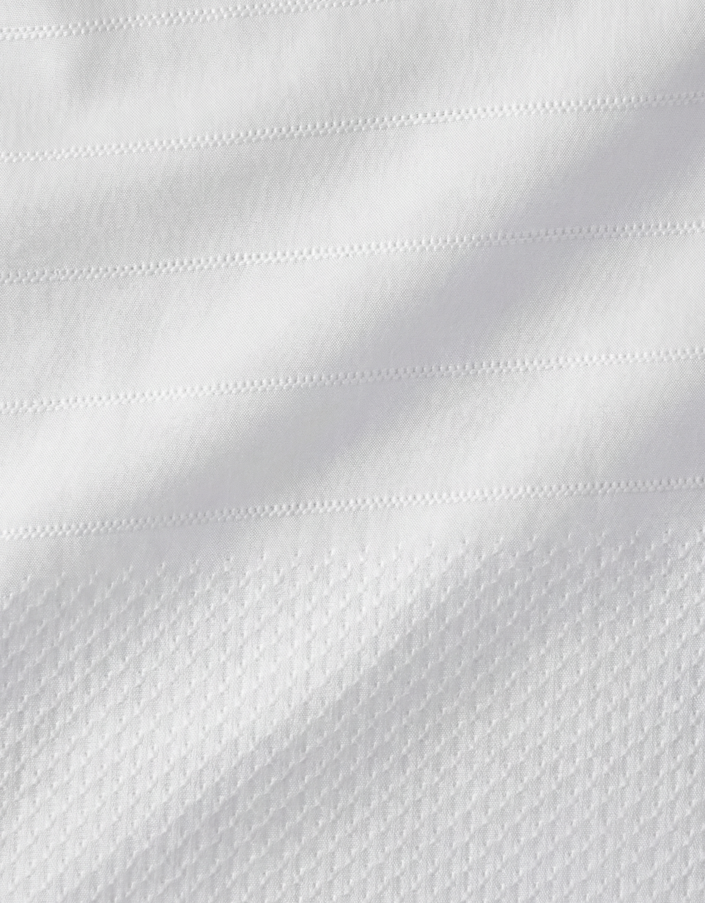 Close-up specialized jacquard polyamide fabric texture on DapperTee Scotland Yard office polo.