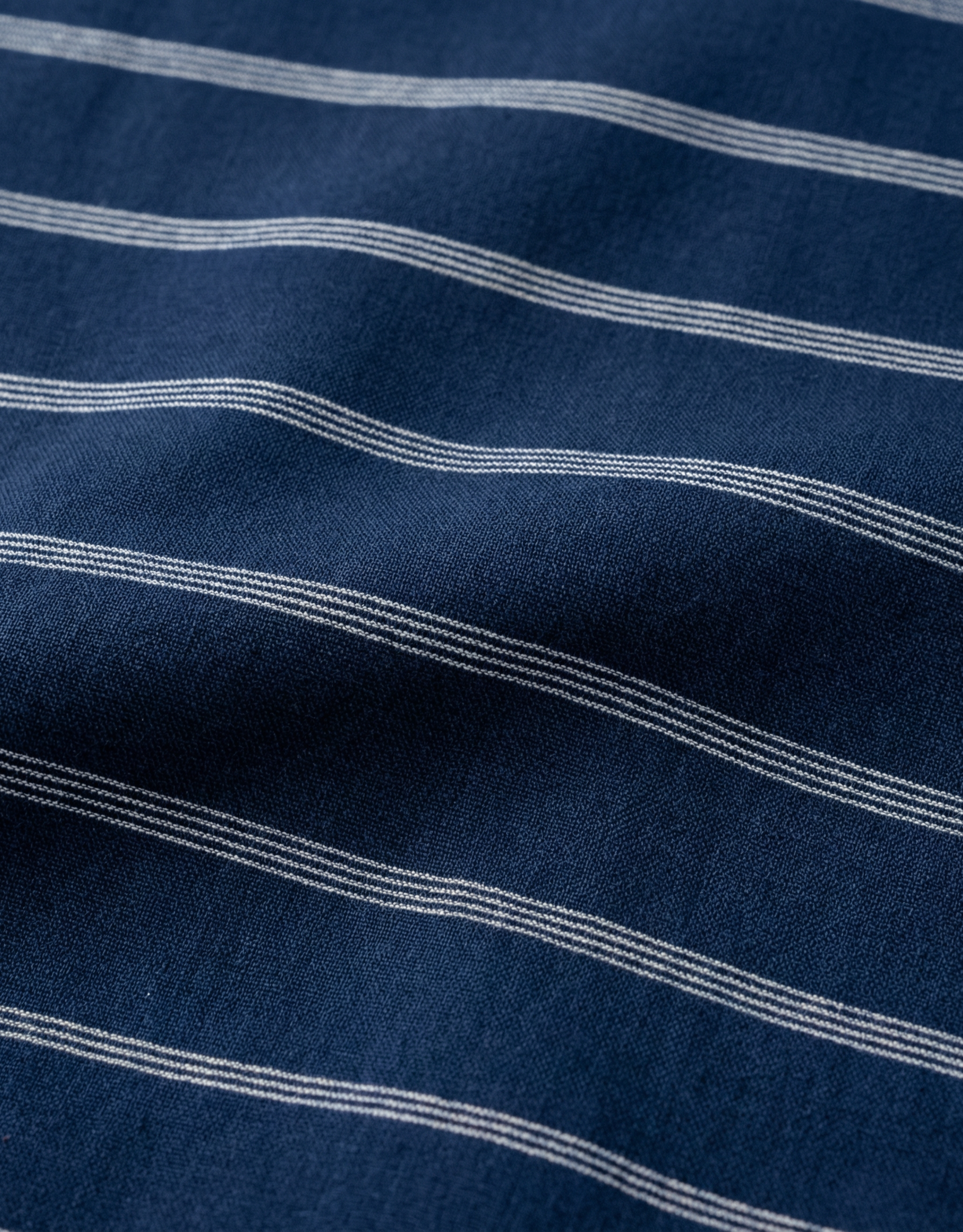 Close-up specialized polyamide fabric texture on DapperTee French Navy striped office polo.