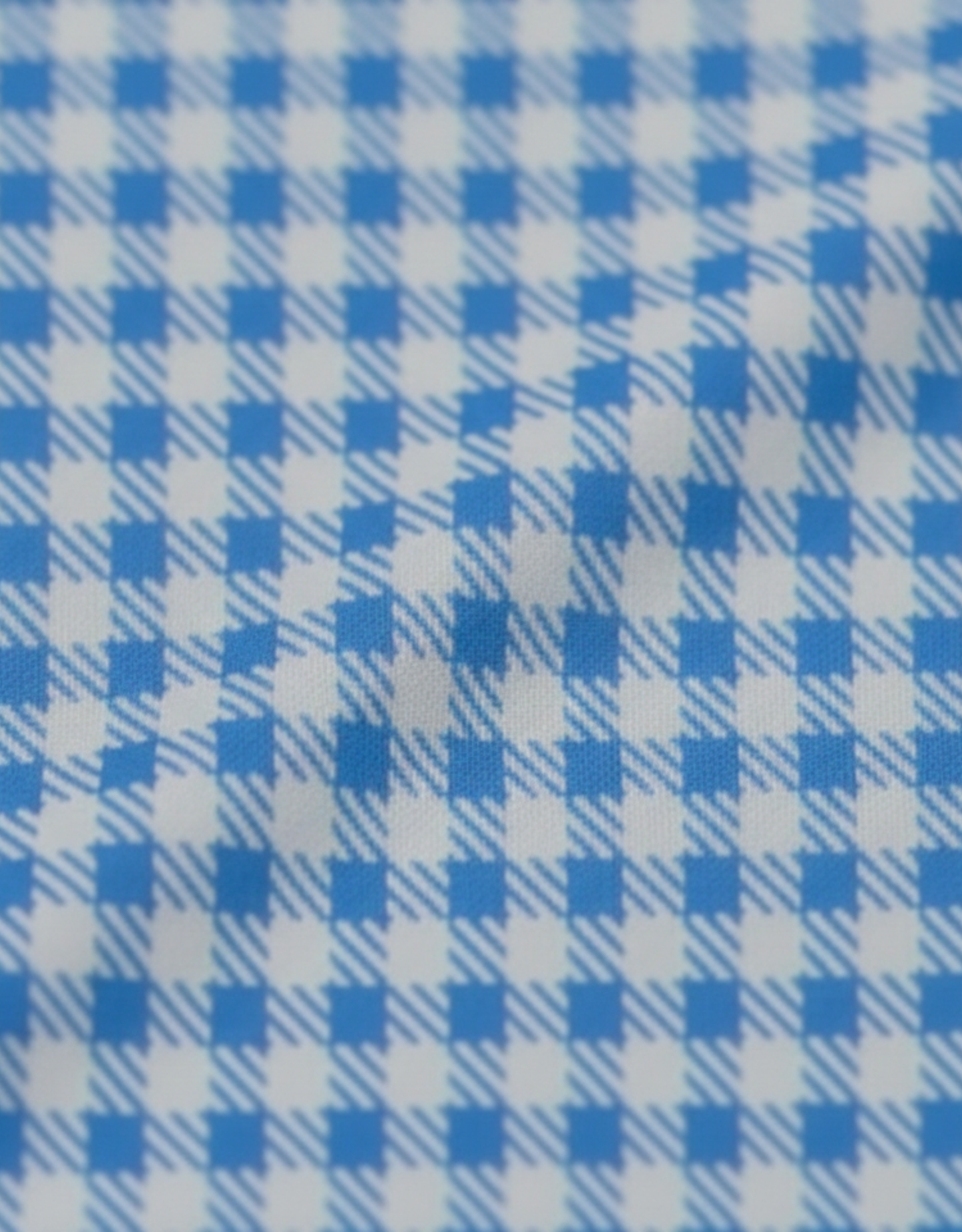 Close-up specialized polyamide fabric texture on DapperTee Financial London checked office polo.