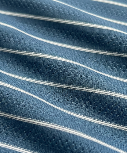 Close-up specialized jacquard polyamide fabric texture on DapperTee navy blue striper shirt.