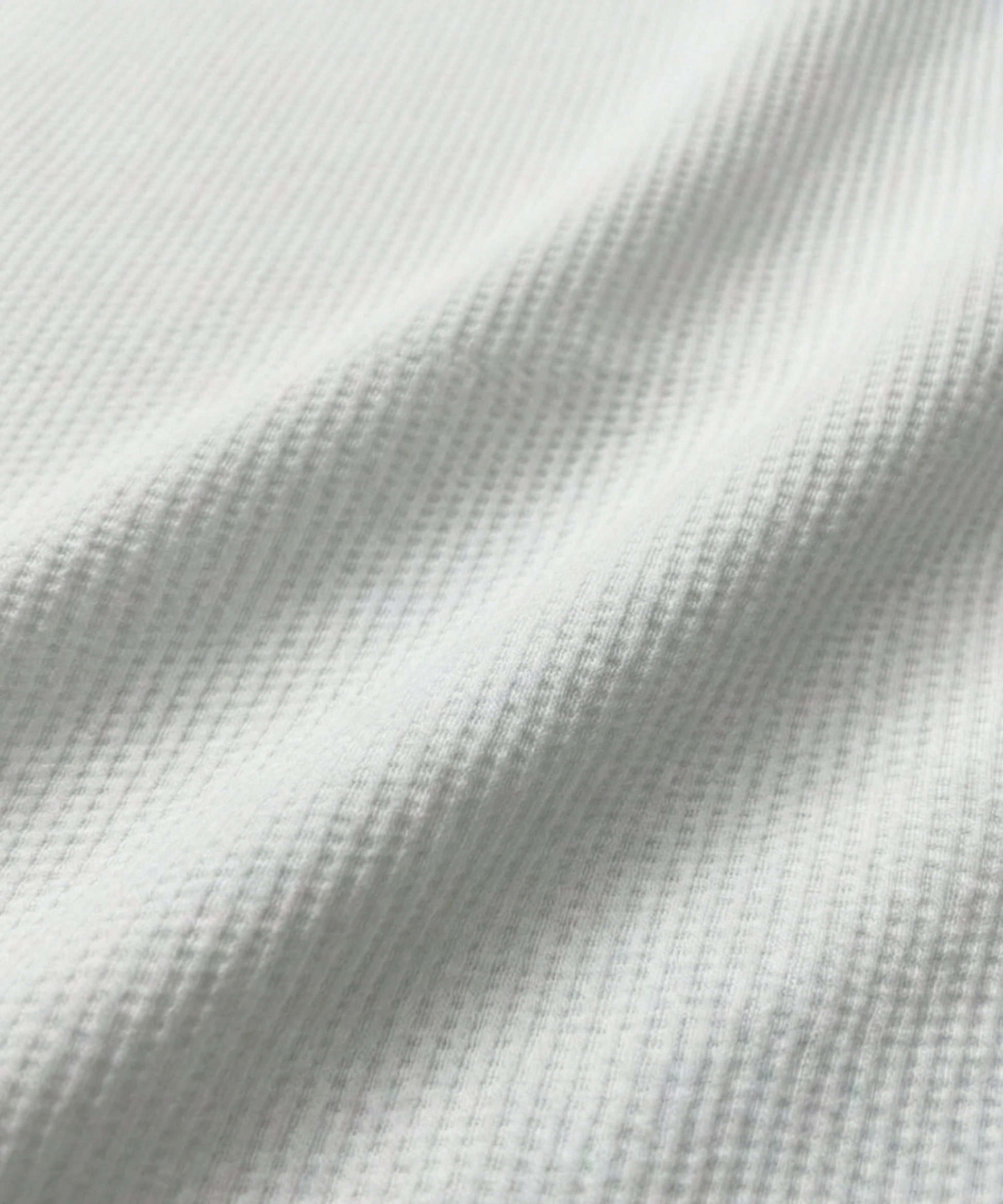 Close-up specialized dot jacquard polyamide fabric texture on DapperTee Regal white shirt.