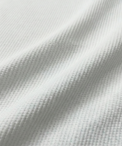 Close-up specialized dot jacquard polyamide fabric texture on DapperTee Regal white shirt.