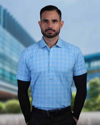 Model wearing DapperTee blue checks polo for a premium corporate boardroom aesthetic.