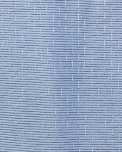 Close-up specialized jacquard knit polyamide fabric texture on DapperTee blue office polo.