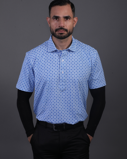 Model wearing DapperTee blue jacquard polo for a premium corporate boardroom aesthetic.
