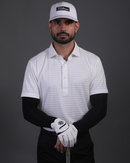 Model wearing DapperTee white stripe polo for a premium corporate boardroom aesthetic.