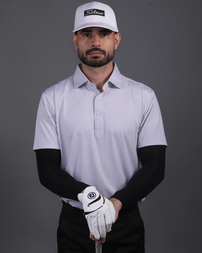 Model wearing DapperTee grey knit polo for a premium corporate boardroom aesthetic.