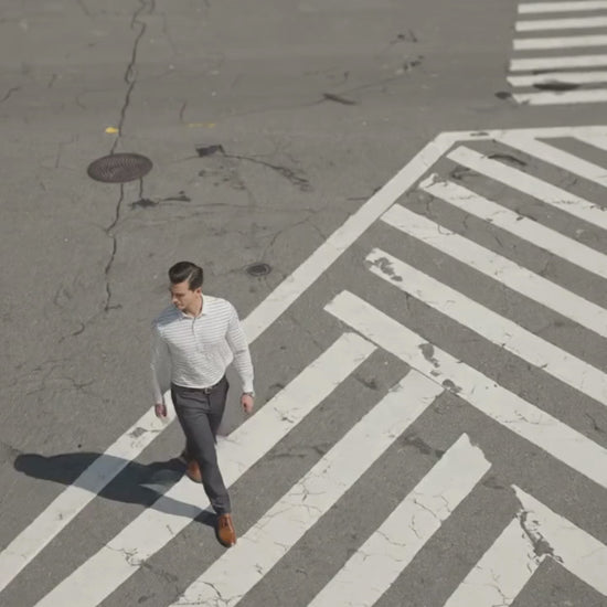 Performance video showcasing DapperTee stretchable long sleeve polo during professional city movement.